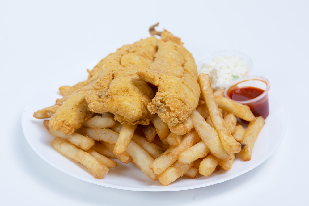 Fresh fried seafood platter with fries, coleslaw, and red sauce