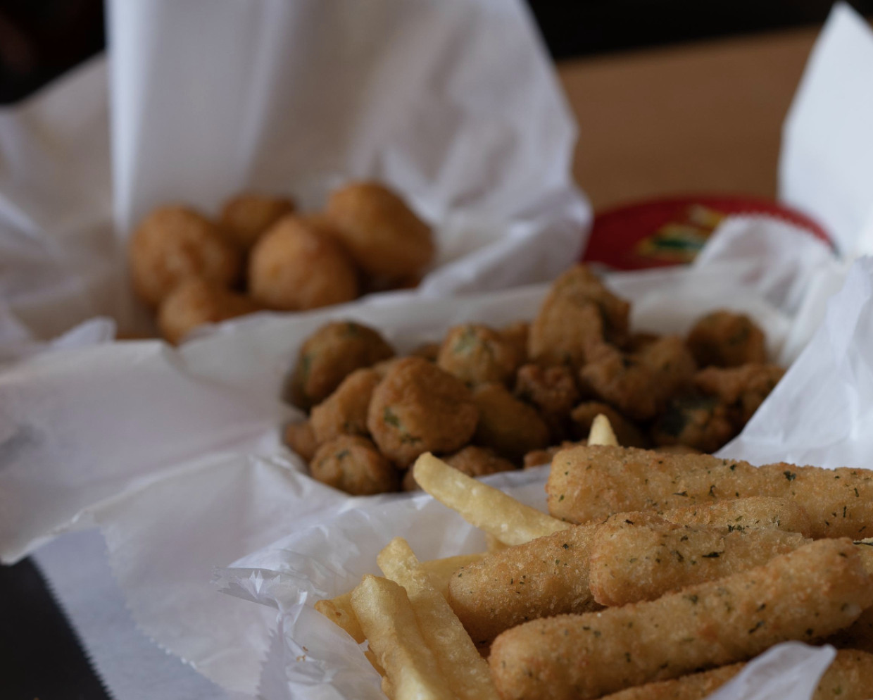 Assorted sides — fries, hush puppies, okra, and more
